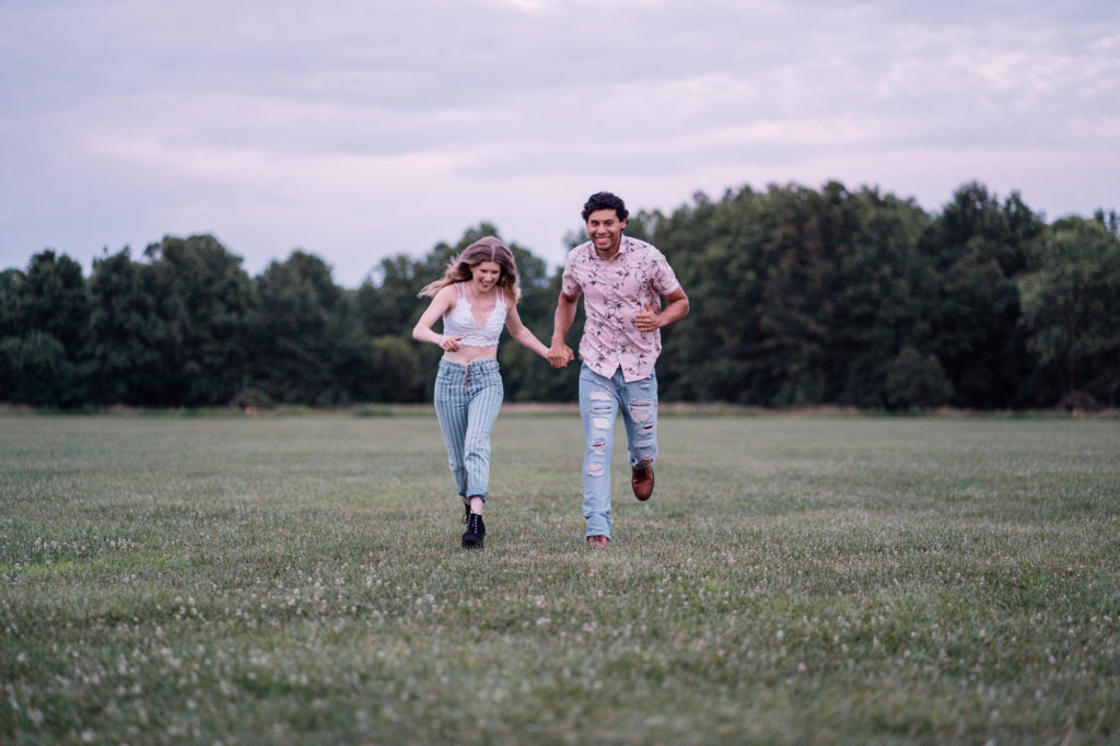 couple running across a field together