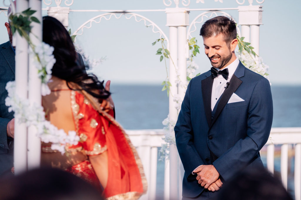 groom laughing during wedding ceremony