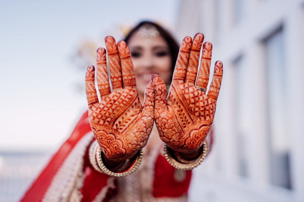 bride shows off henna hand designs
