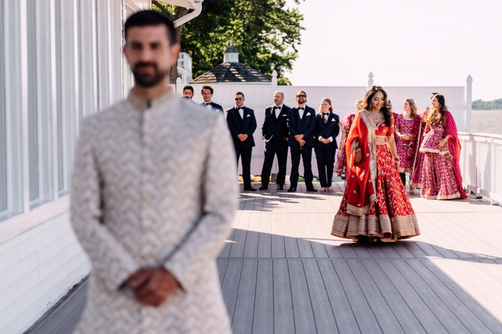indian bride walking towards groom for their first look