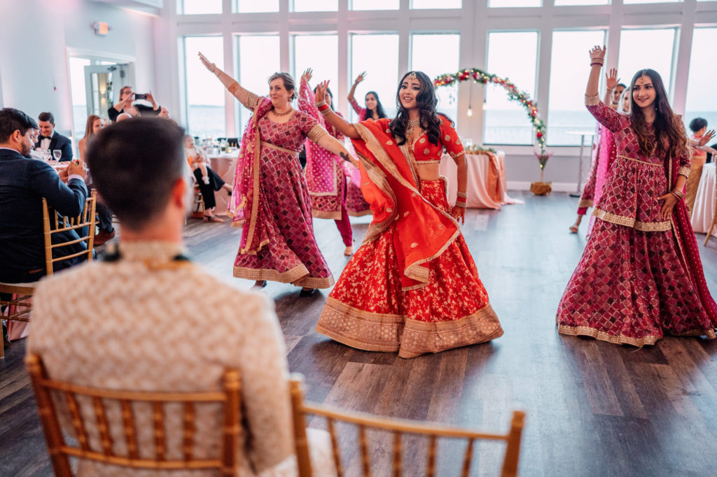 bride and bridesmaids performing choreographed dance for the groom
