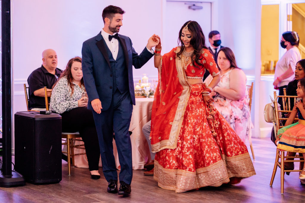 bride and groom walk into reception for their first dance