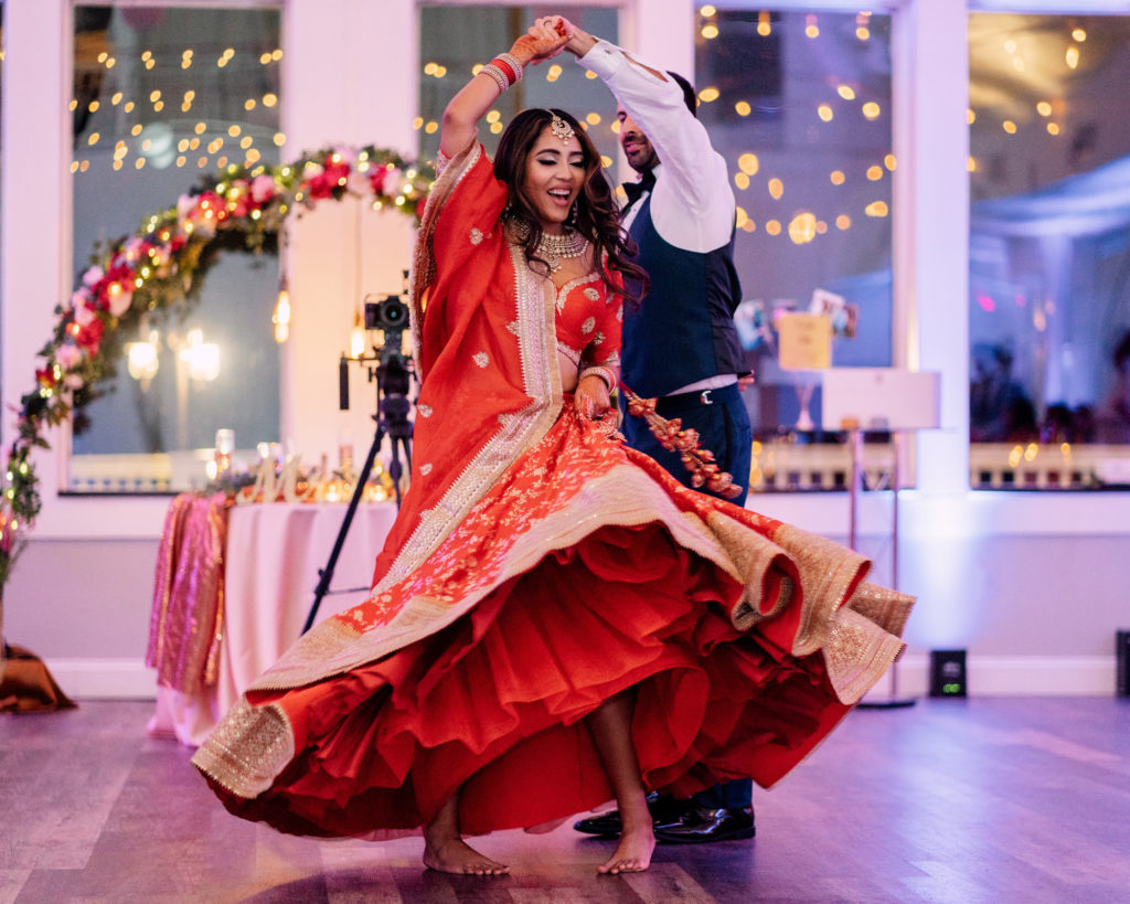 groom twirls bride during their first dance