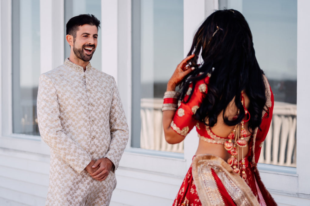 groom turns around and smiles as he see's his bride for the first time