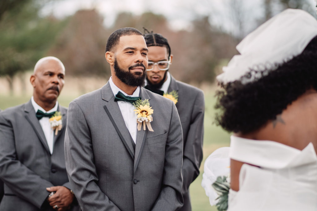 groom looking at bride during their wedding ceremony