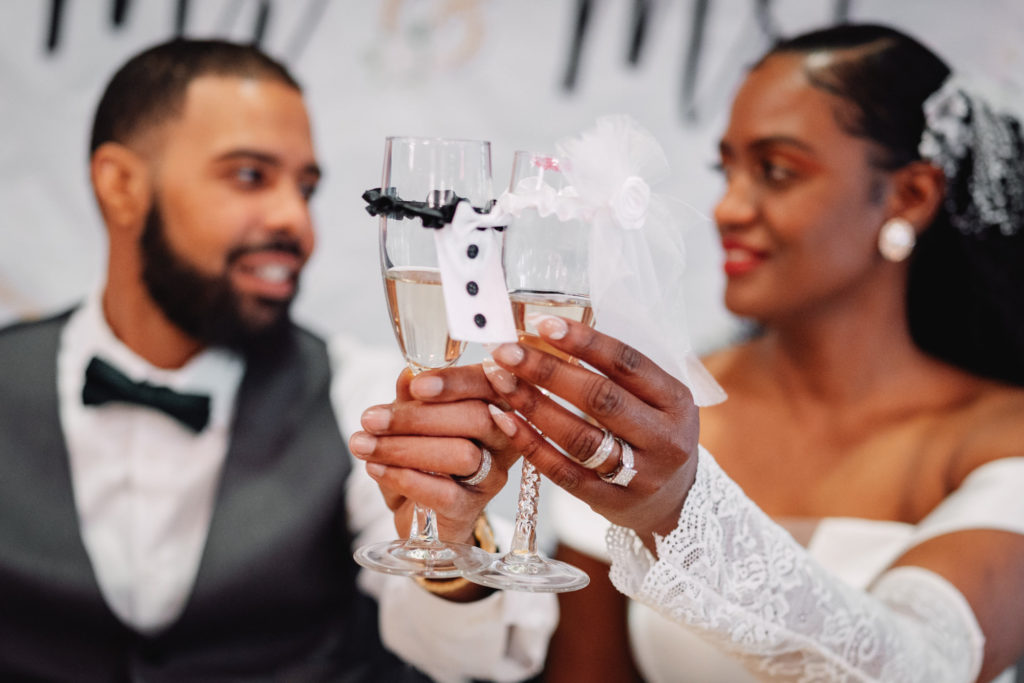 bride and groom sharing a glass of champagne during their wedding reception