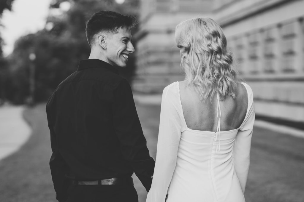 groom looking at bride and smiling during engagement photography session