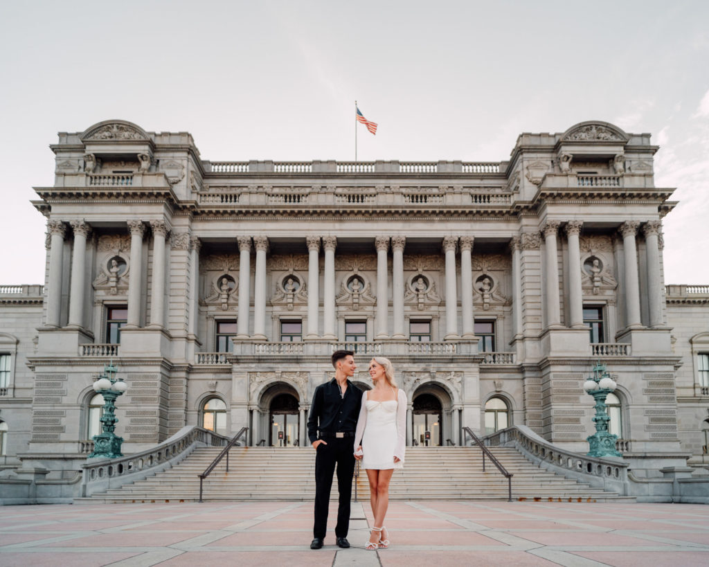 bride and groom interacting in front of the library of congress in washington dc