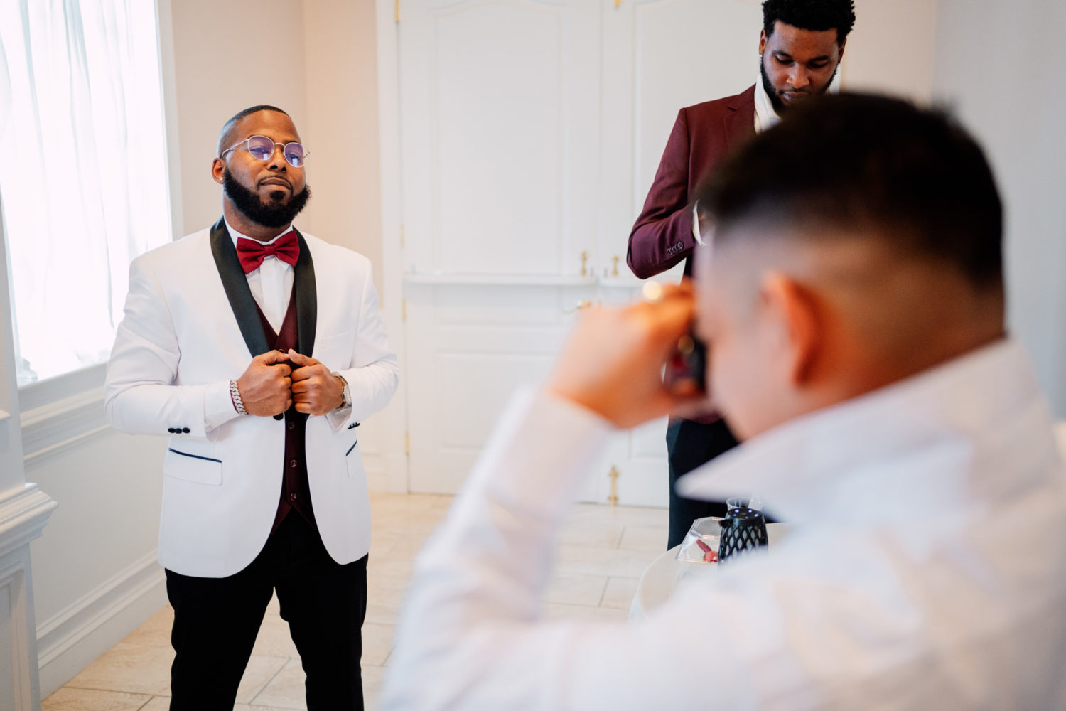 groom getting his polaroid photo taken by his groomsmen