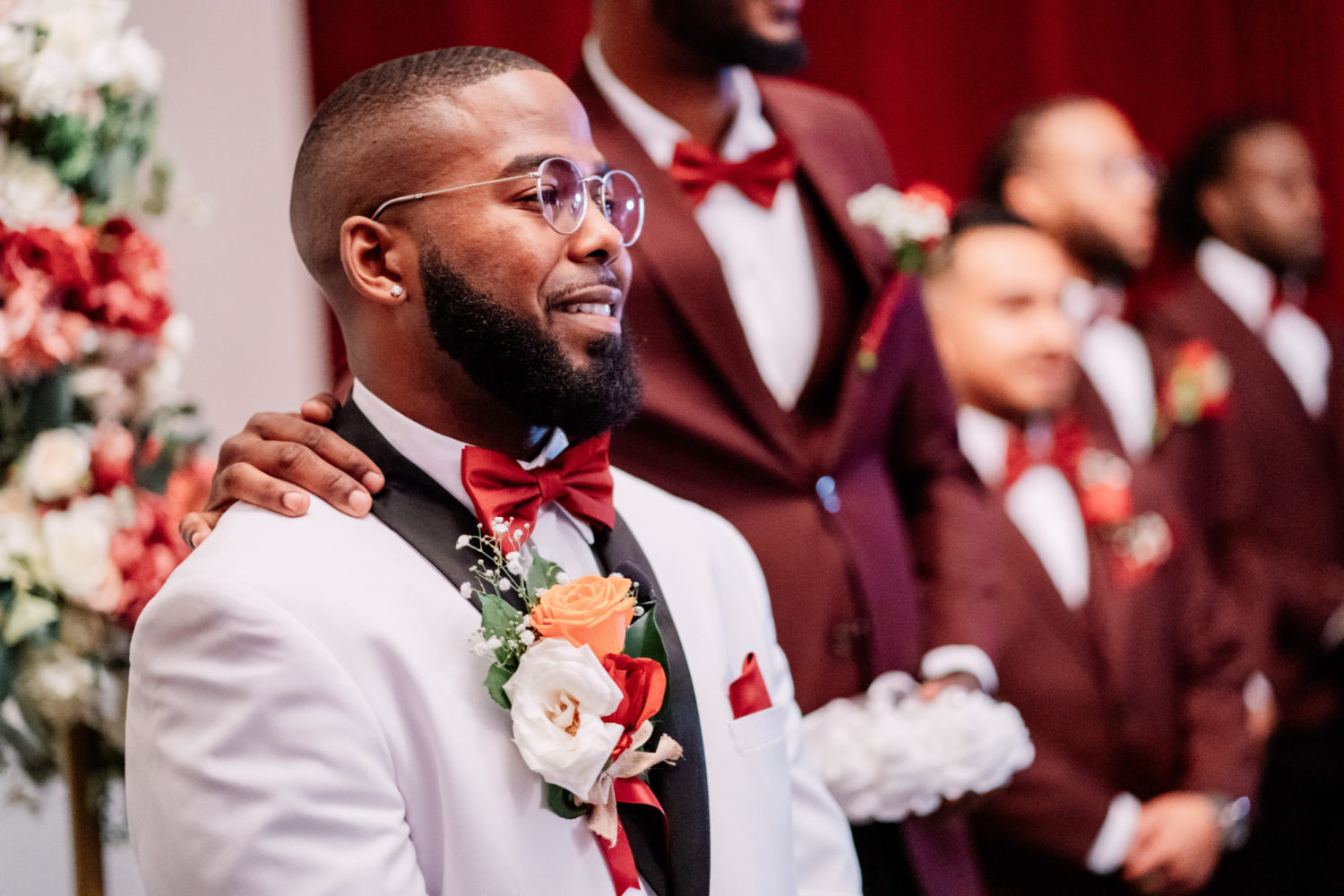 groom smiling when seeing his bride walk down the aisle on their Foxchase manor wedding day