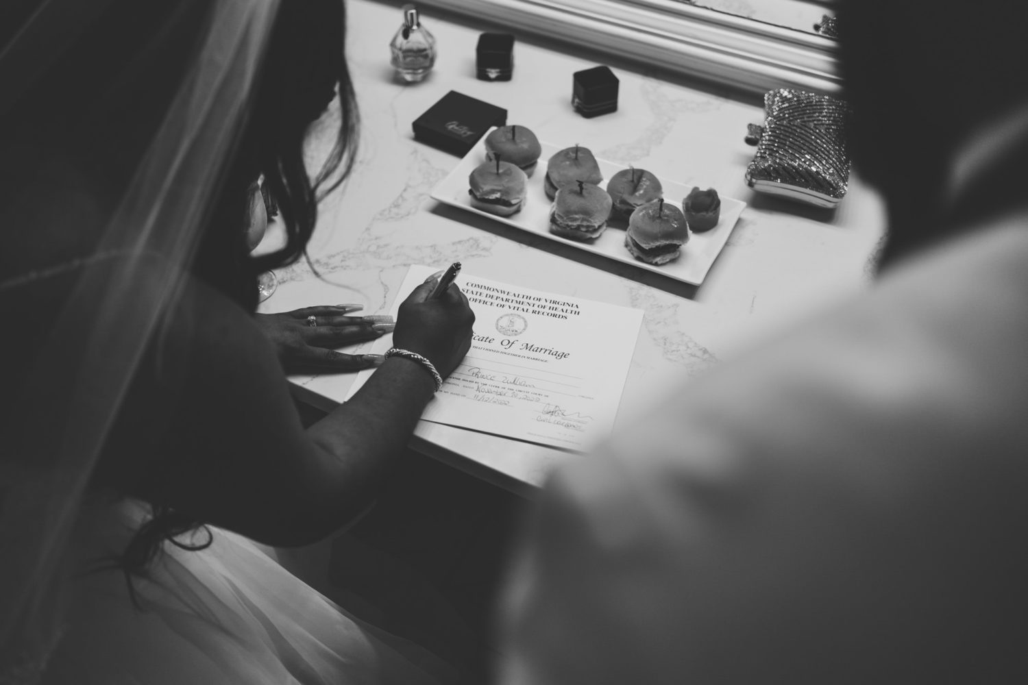 bride and groom signing their marriage certificate 