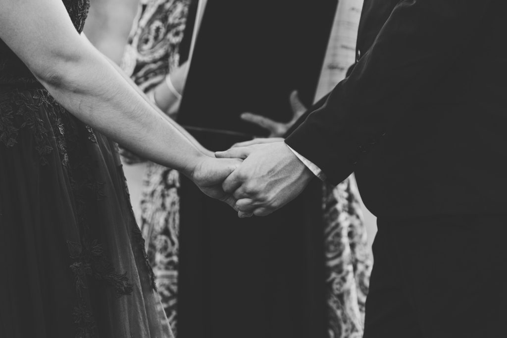 bride and groom holding hands during wedding ceremony in Northern Virginia