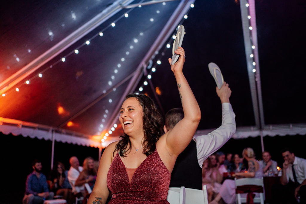 bride and groom play shoe game during their wedding reception