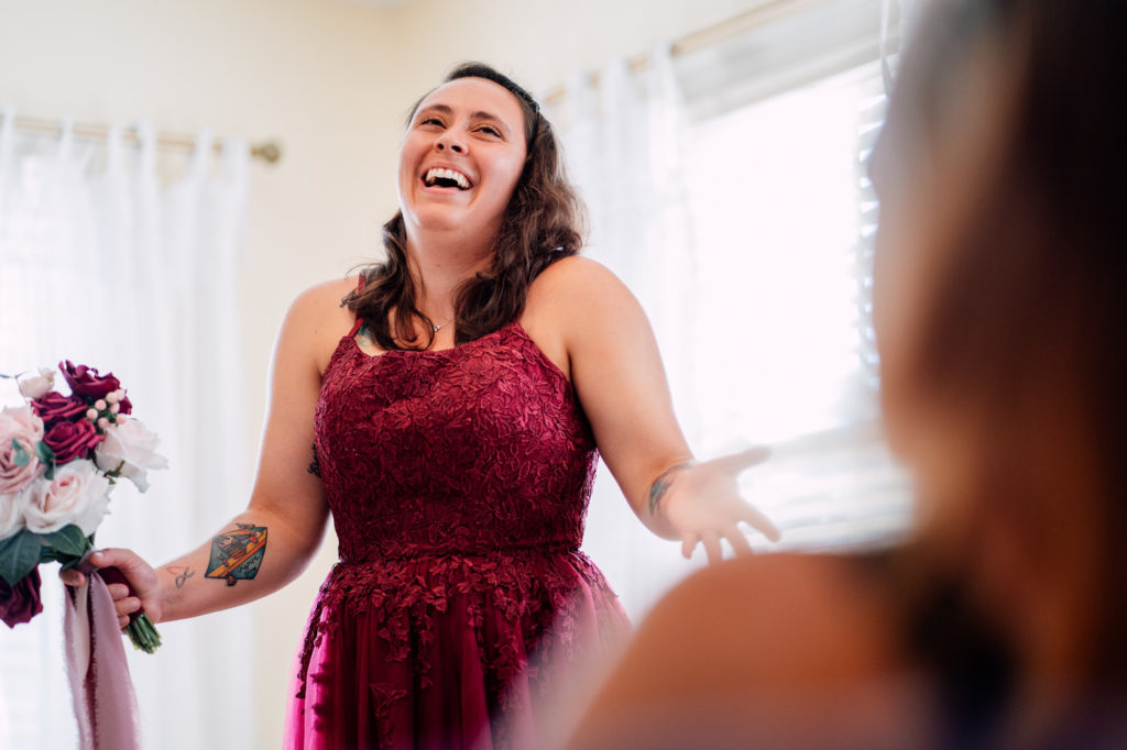 bride laughing while hanging out with bridesmaids