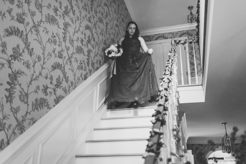 bride walking down stair steps before first look with father