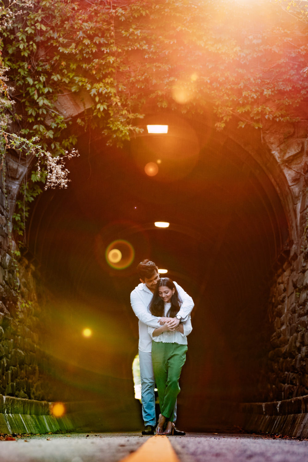 couple hugging each other and interacting during sunrise at wilkes tunnel in old town alexandria