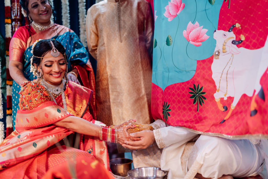 bride and groom share coconut during their indian wedding