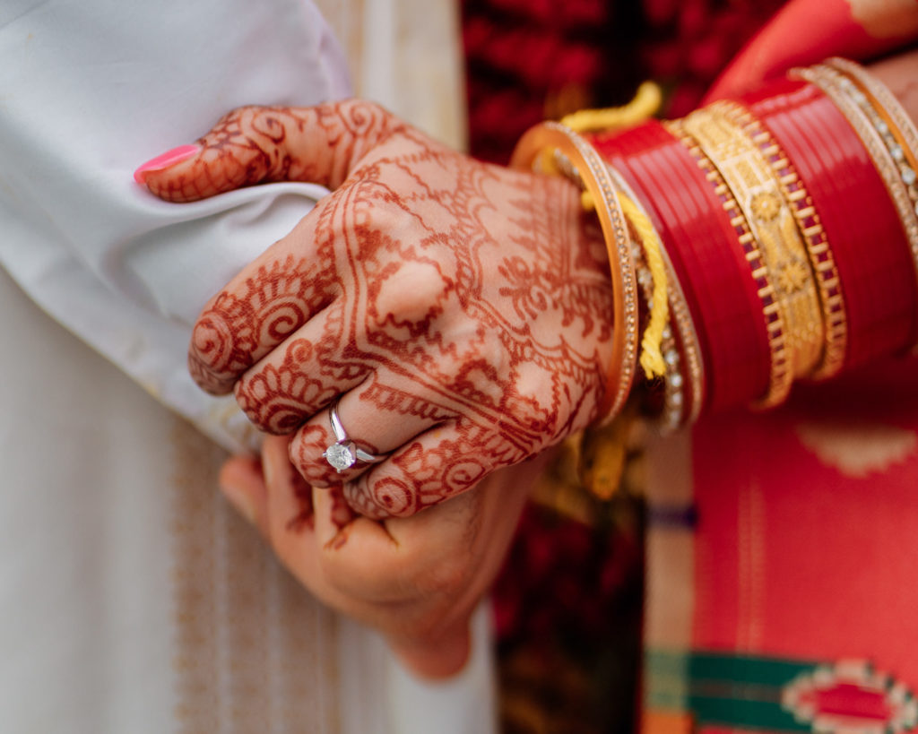 indian bride and groom holding hands during indian wedding in maryland