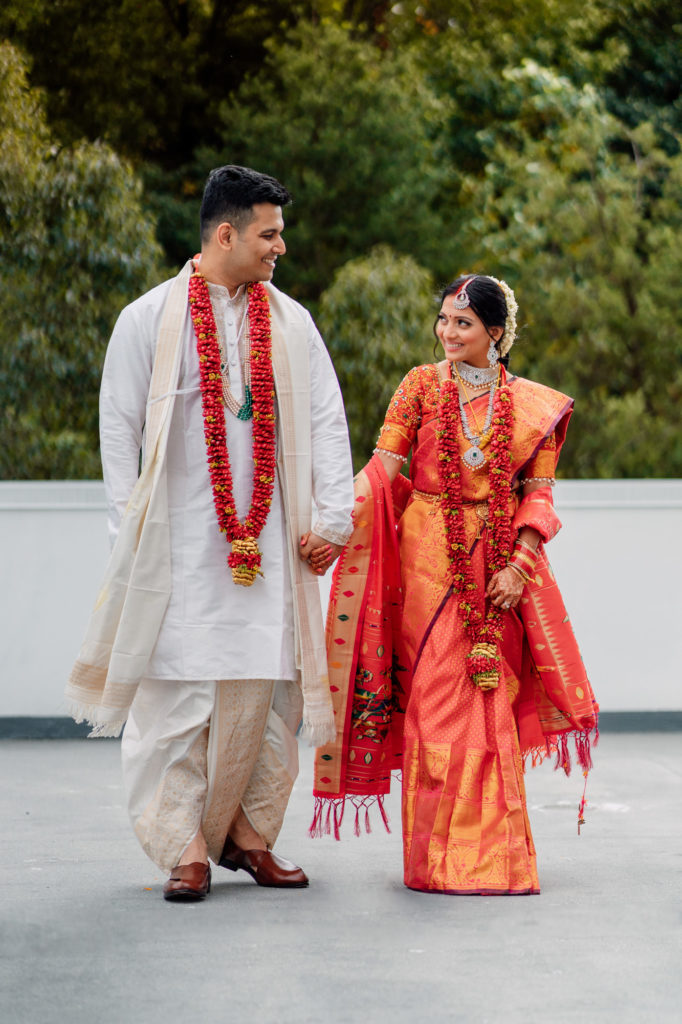 indian bride and groom walking together and smiling together