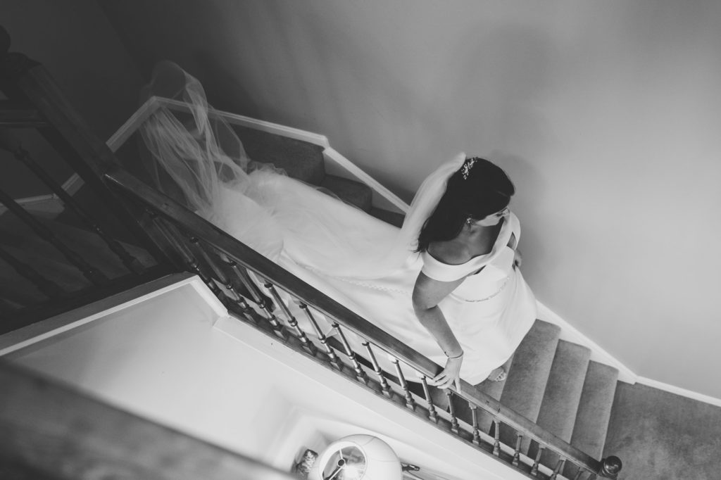 bride walking down stairs before her wedding ceremony