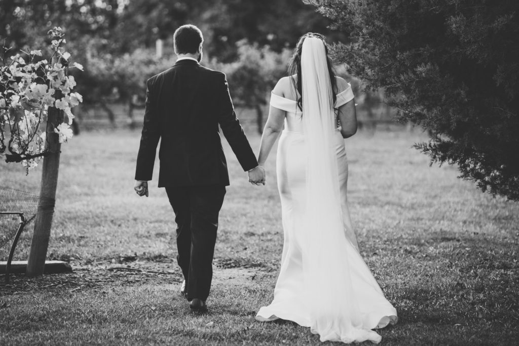 bride and groom walking to vineyard at a Northern Virginia wedding