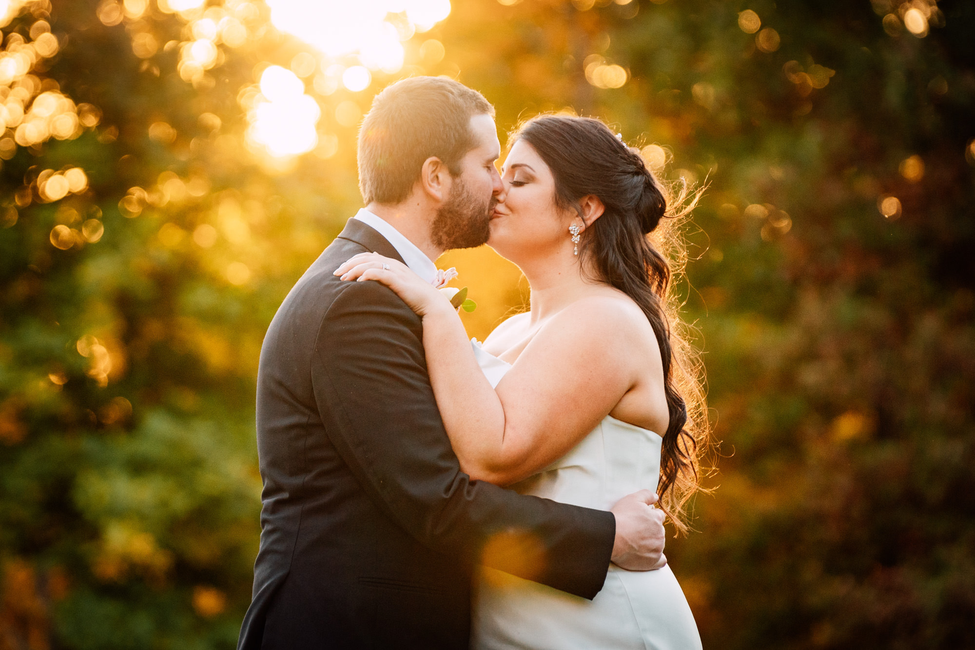 bride and groom kissing during sunset at their Northern Virginia wedding