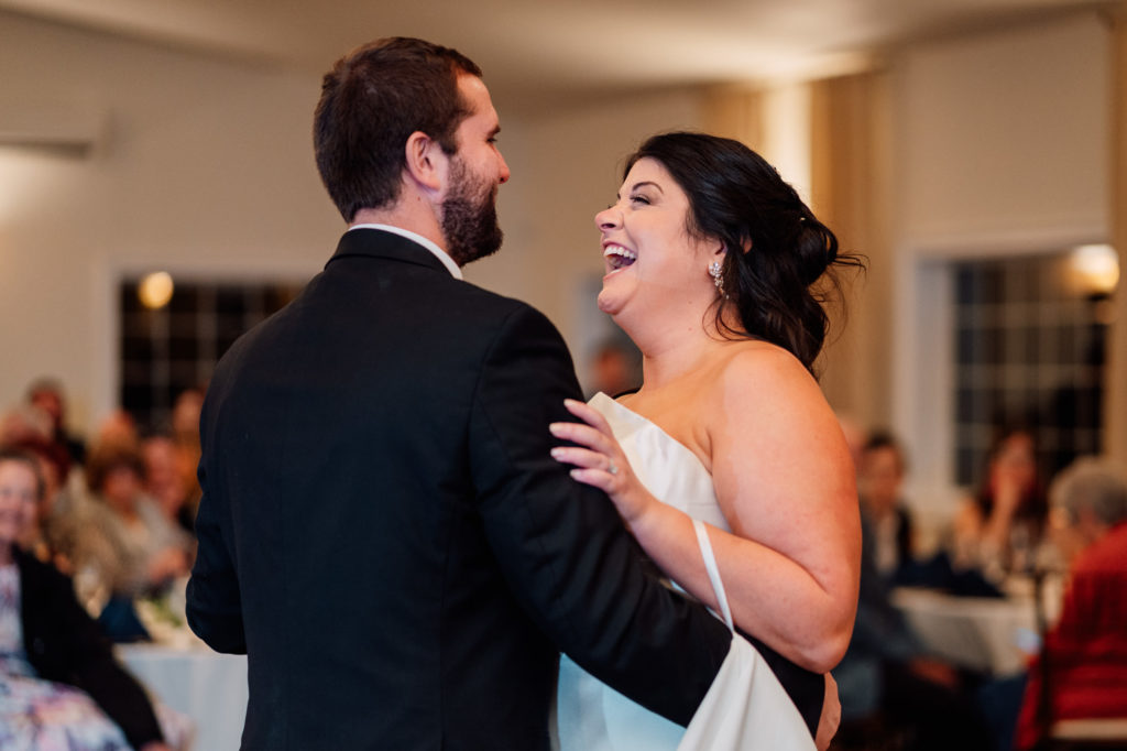 bride and groom laughing together during their first dance