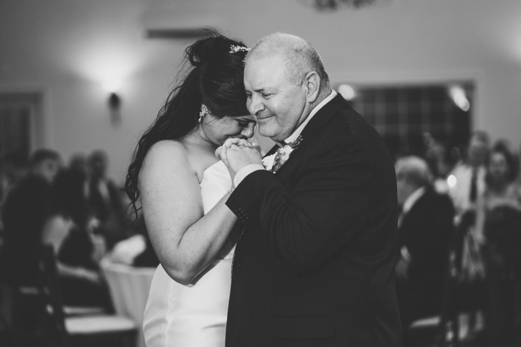 bride gets emotional during her dance with her father at her harvest house at lost creek winery wedding