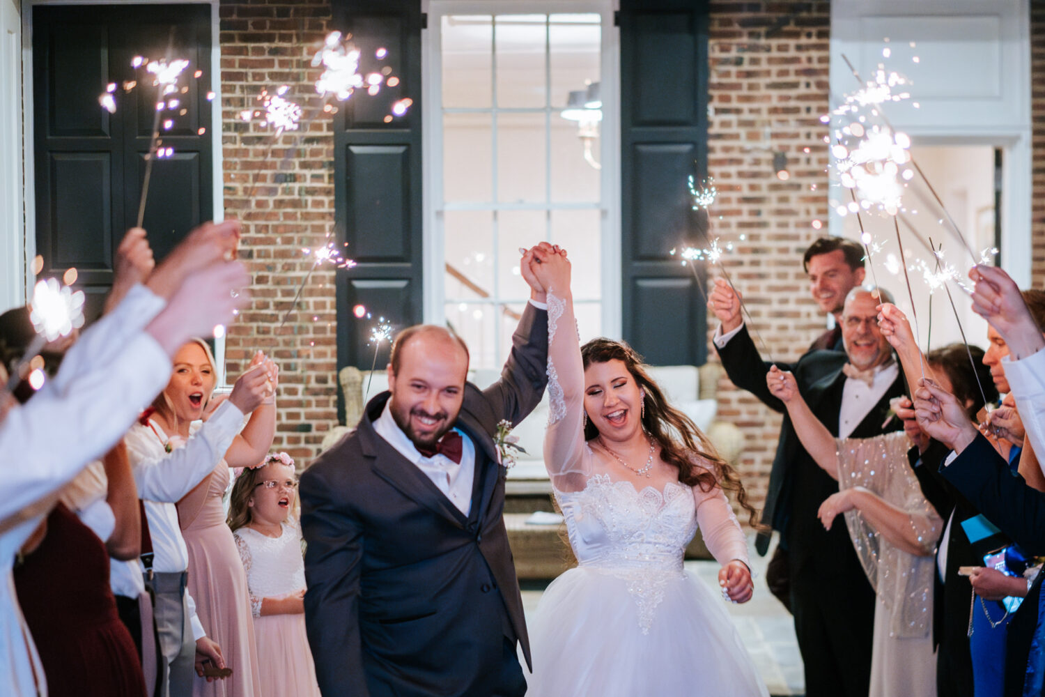 bride and groom having fun during sparkler exit