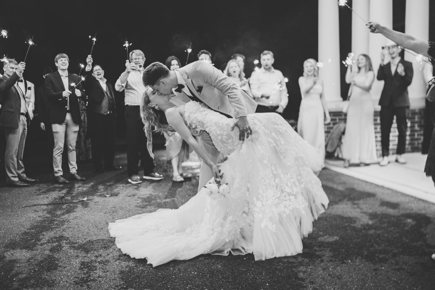 bride and groom kissing during their sparkler exit at their springfield country club wedding