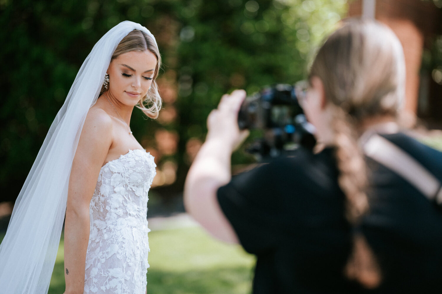 bride working with a videographer on her wedding day