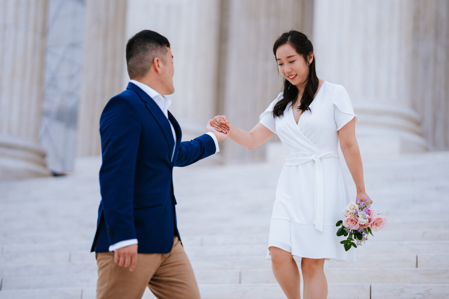 bride and groom walking together down a stair set in washington dc