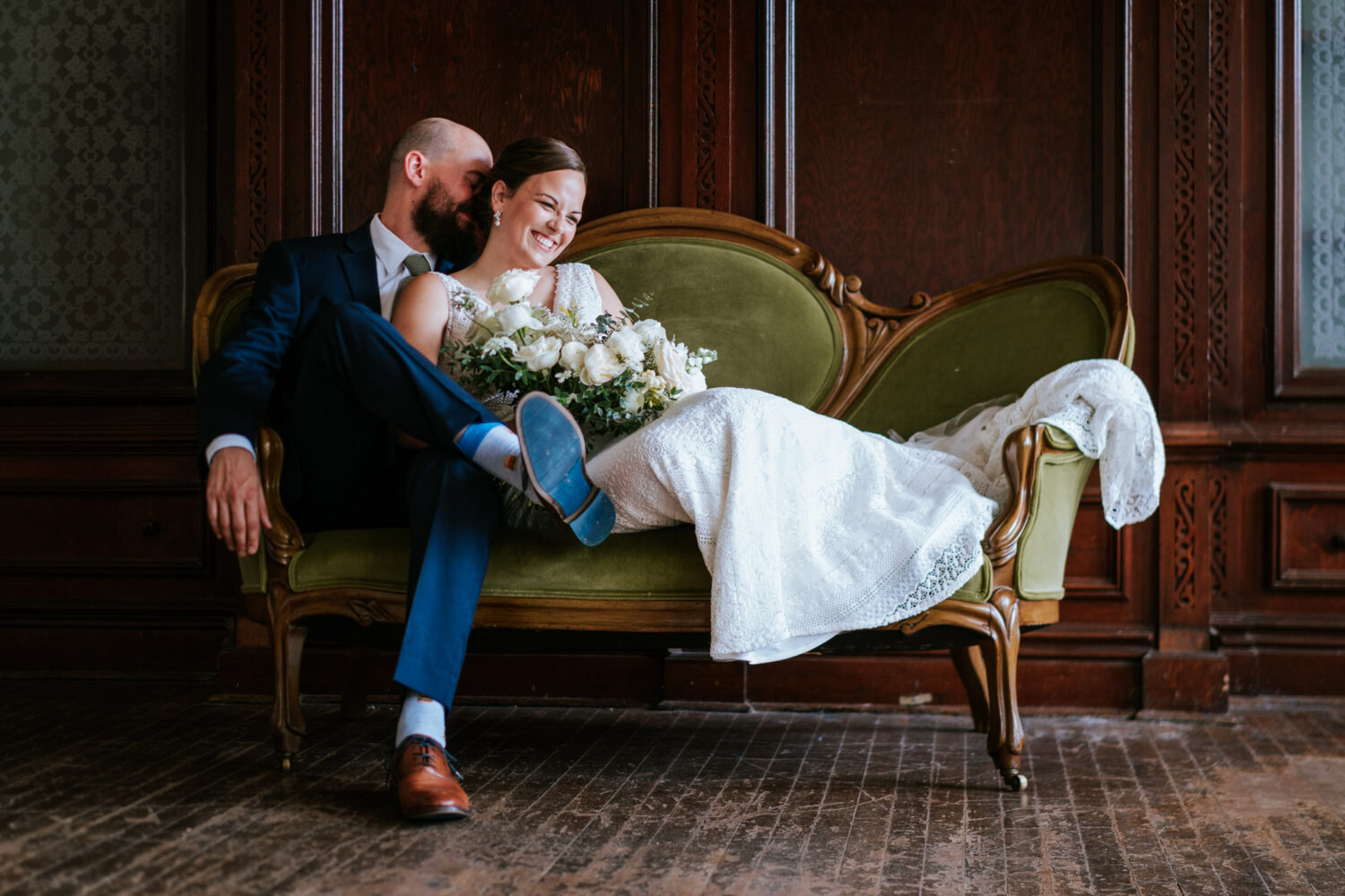 bride and groom couch portrait at the clifton mansion on baltimore maryland