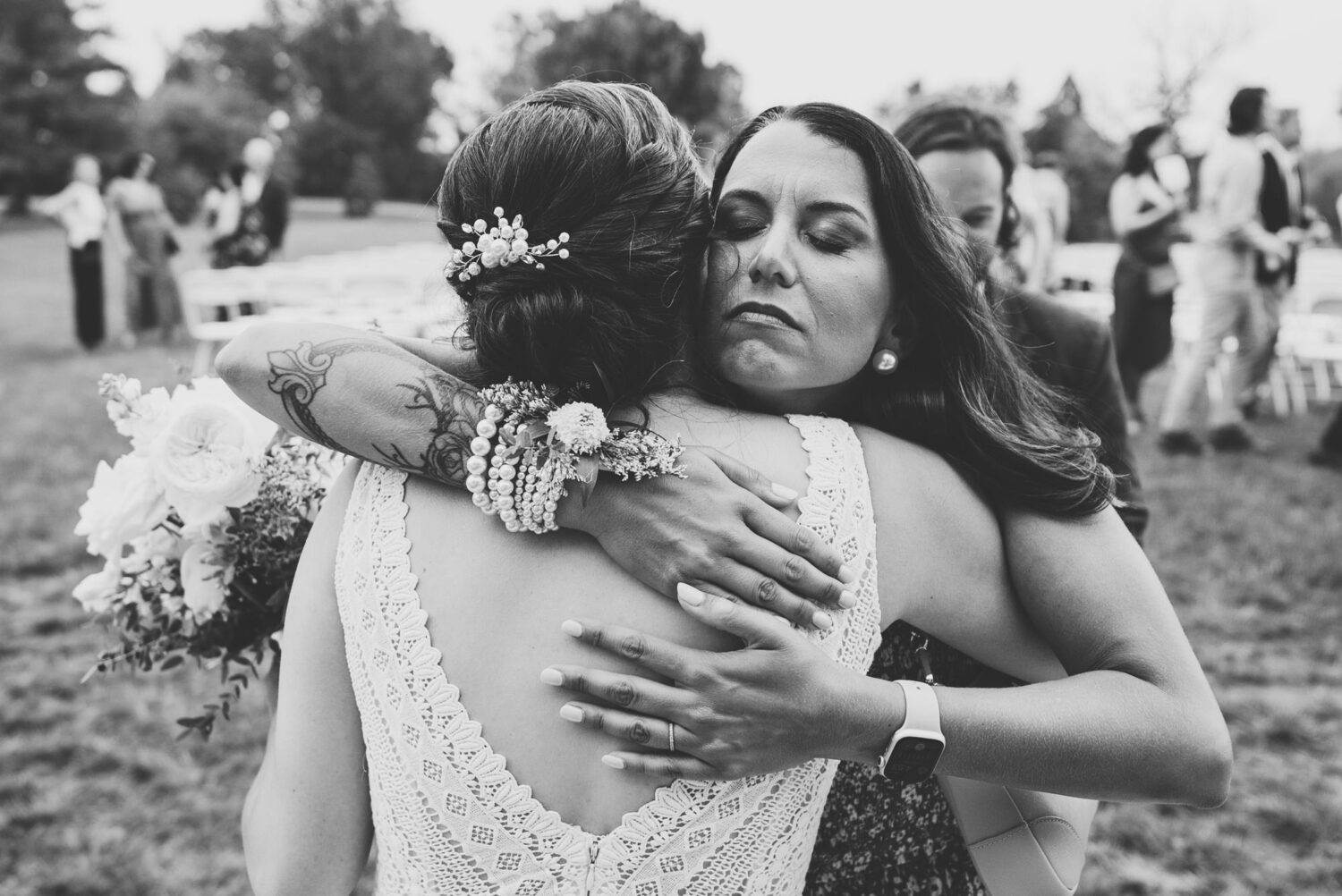 bride hugs sister after their wedding ceremony concludes