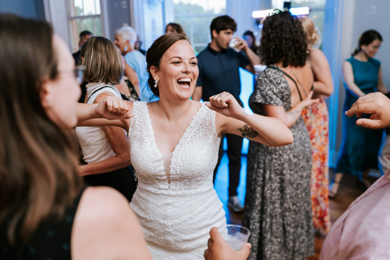 bride dancing with her friends on her wedding day