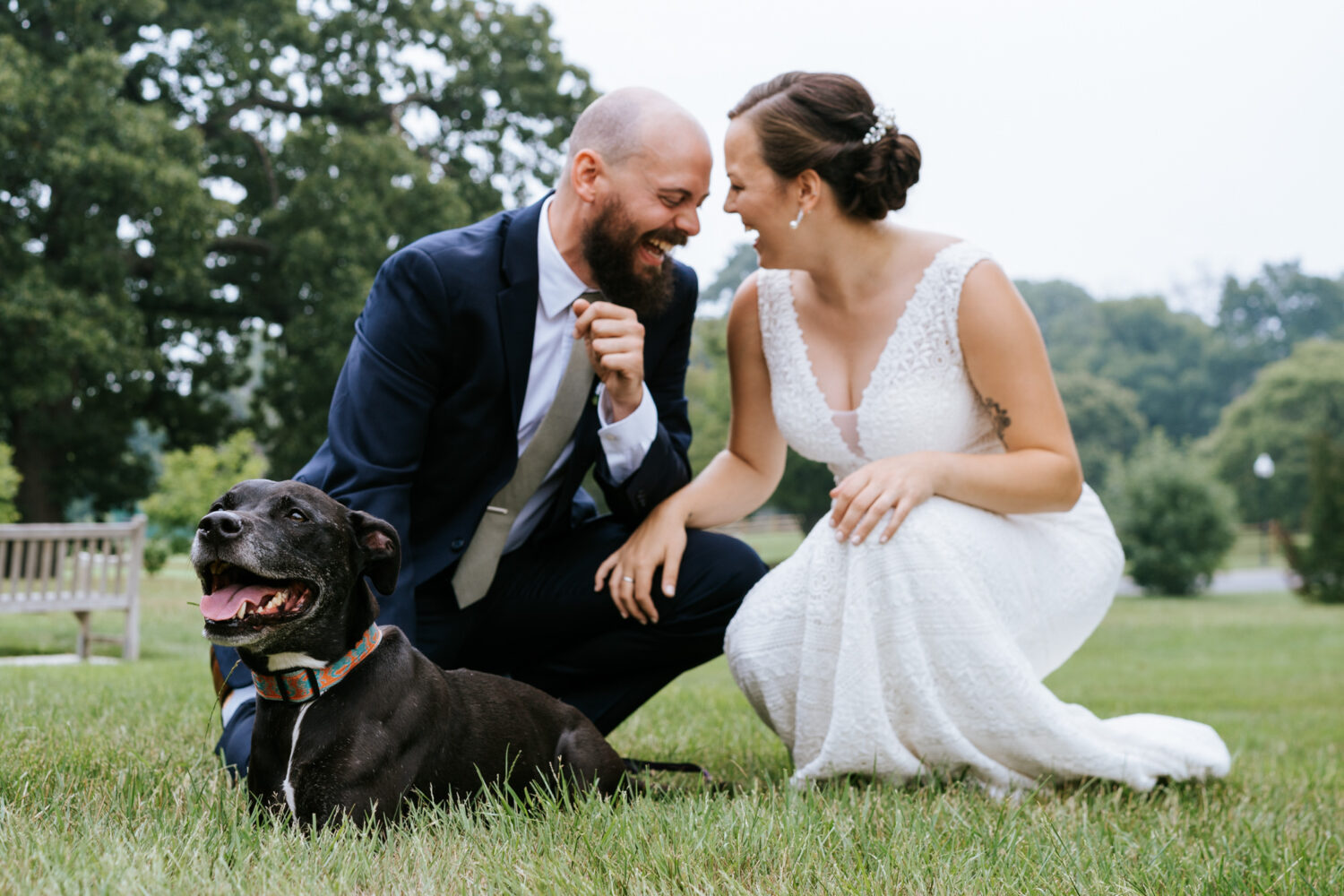 bride and groom laughing together with their dog