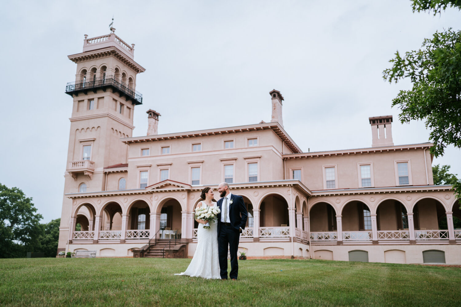 bride and groom portrait in front of the clifton mansion building in baltimore maryland
