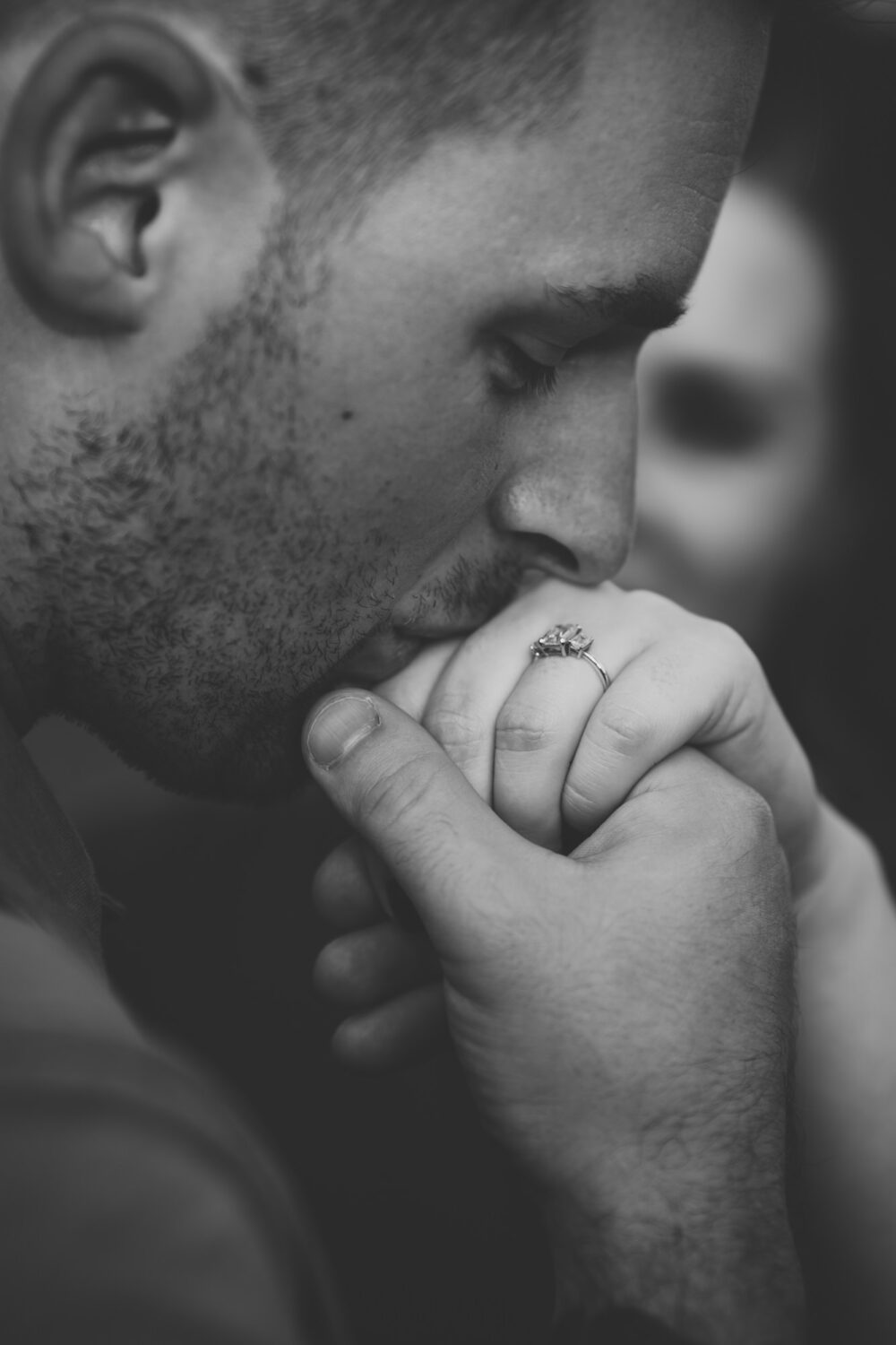 guy kissing his fiancé's hand during their engagement session