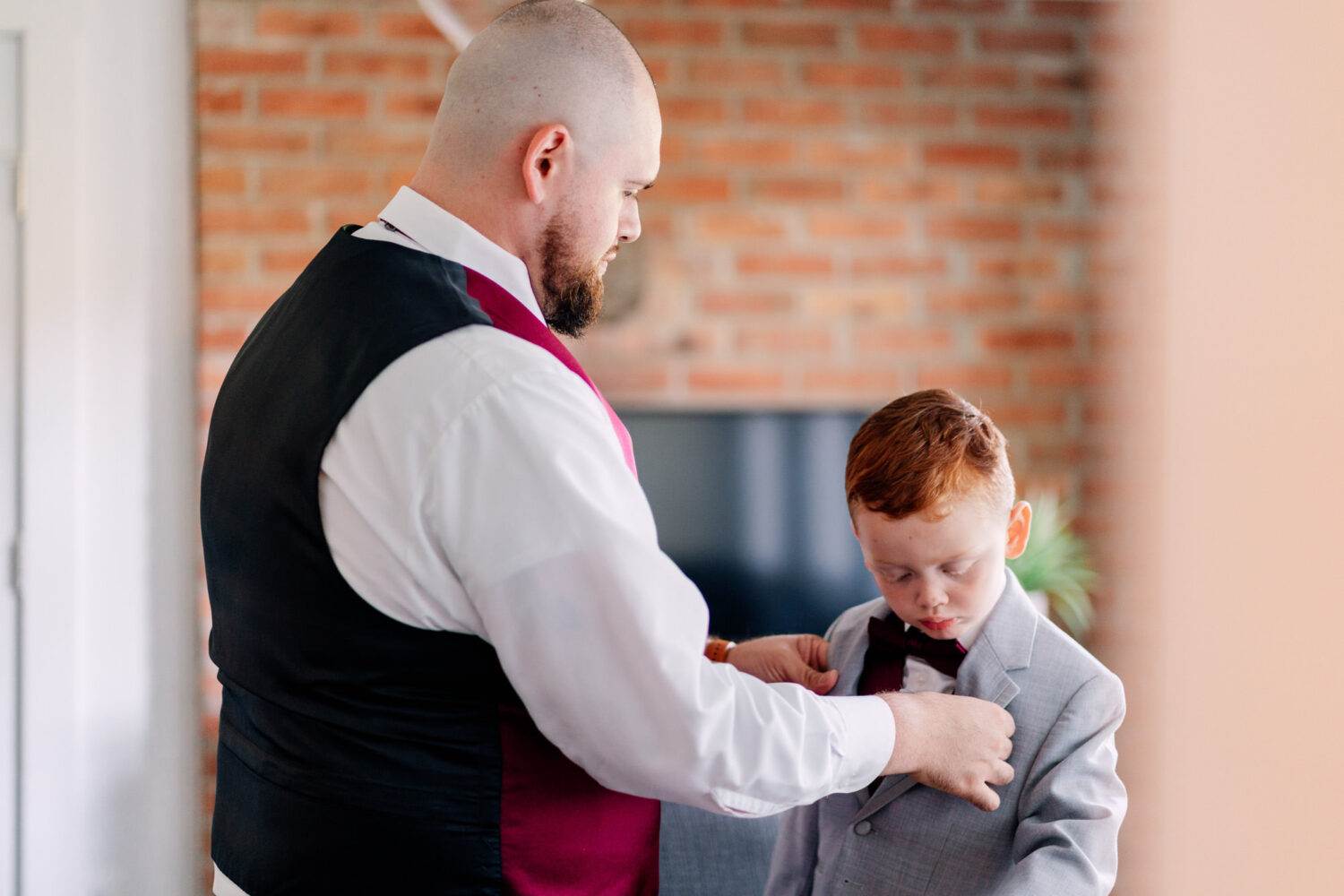groom getting his son ready for the wedding day