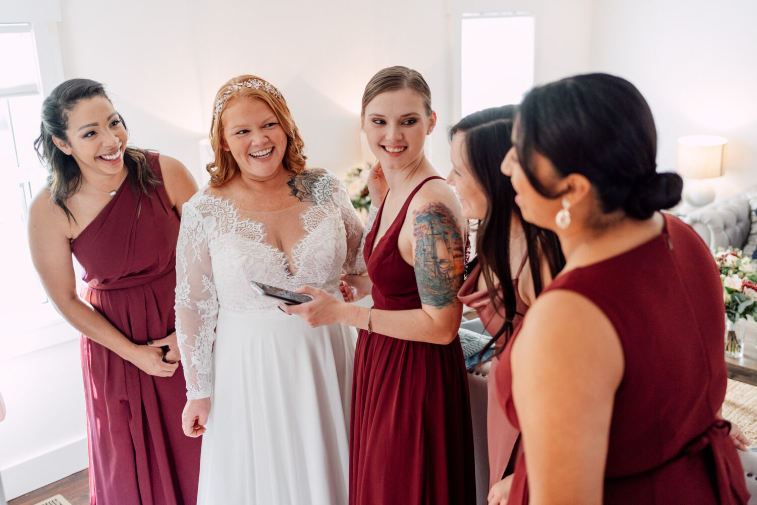 bride and her bridesmaids having fun together before the wedding day