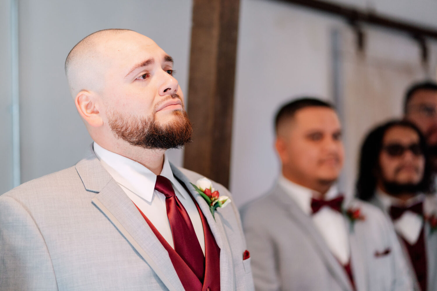 groom nearly in tears watching his bride walk down the aisle