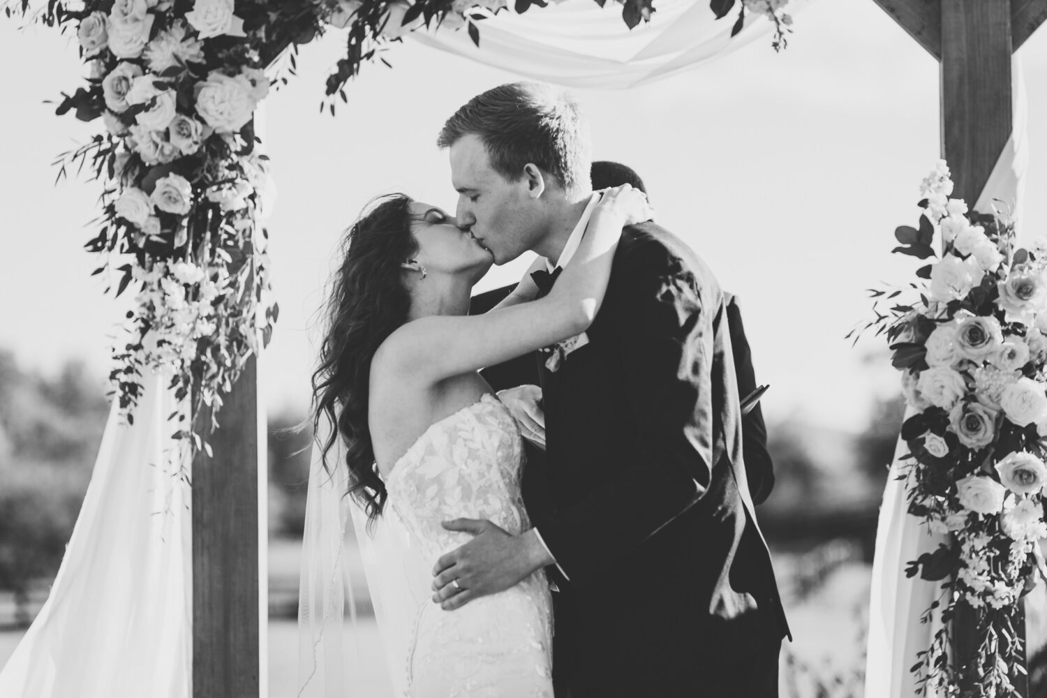 bride and groom share their first kiss on their middleburg barn wedding day
