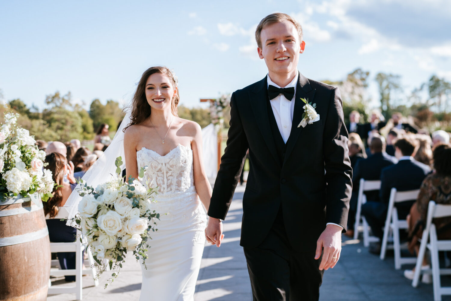 bride and groom walk out of their middleburg barn wedding ceremony together