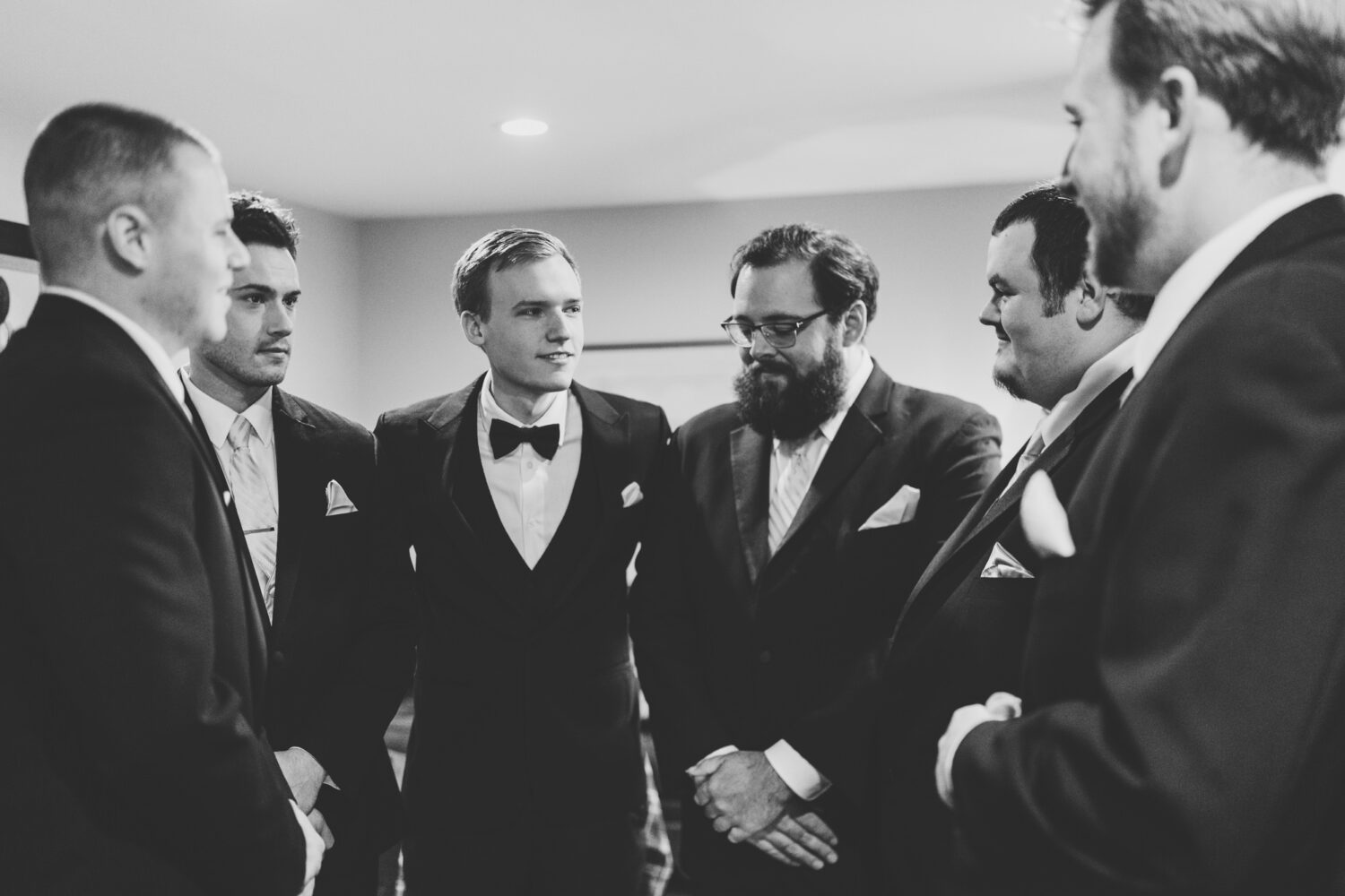 groom hanging out with his groomsmen on his wedding day