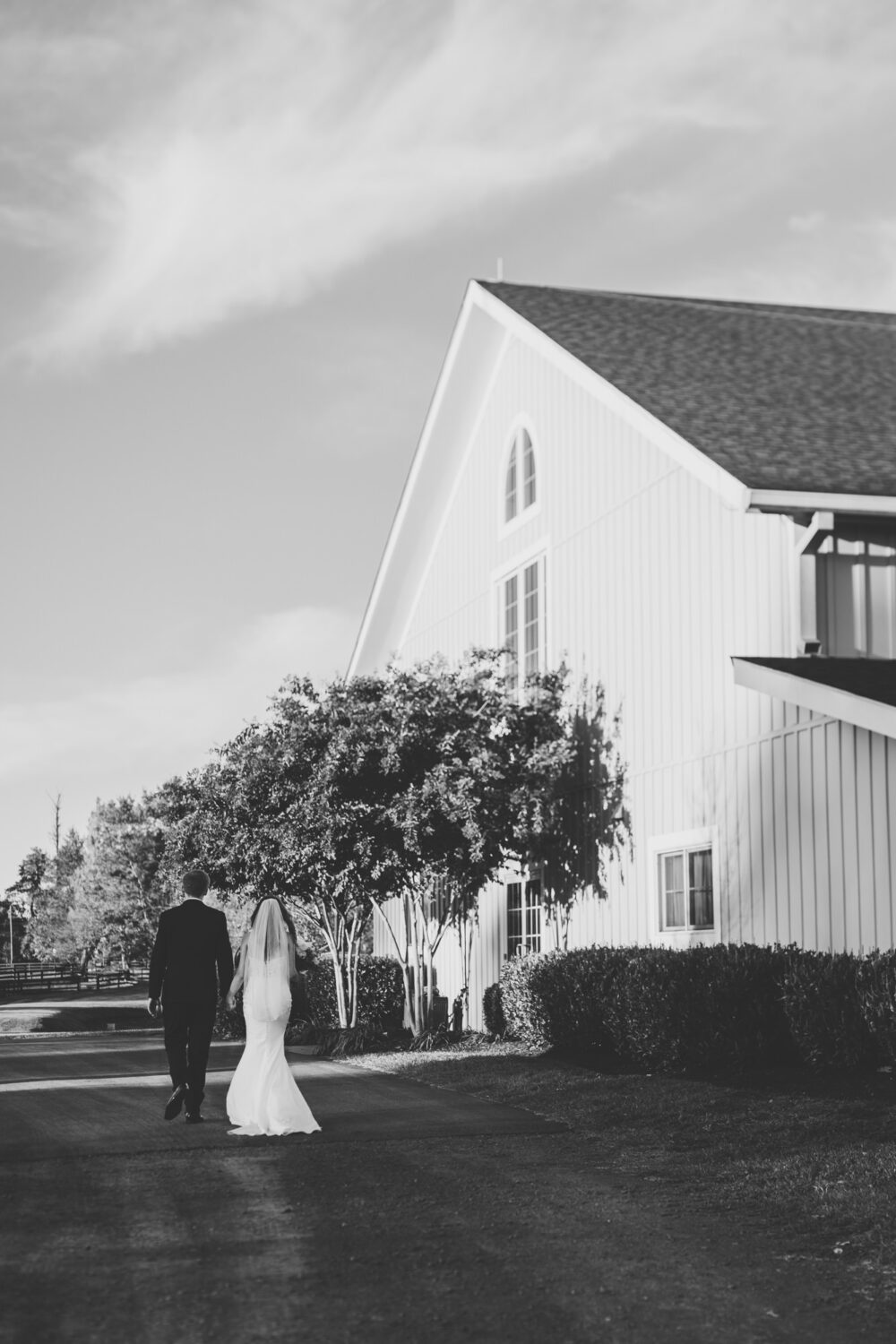 bride and groom walking back to the middleburg barn wedding venue after portrait time