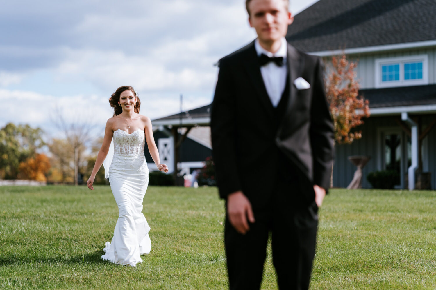 bride walking up to groom for their first look on their middlebirg barn wedding day