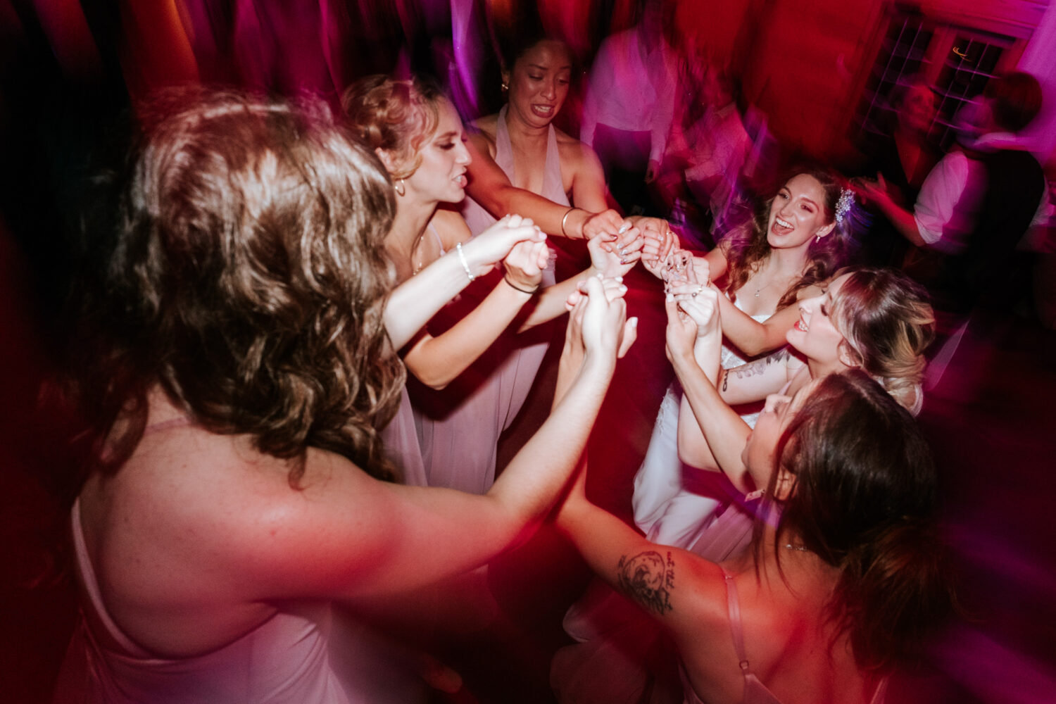 bridesmaids having fun together with the bride and dancing together