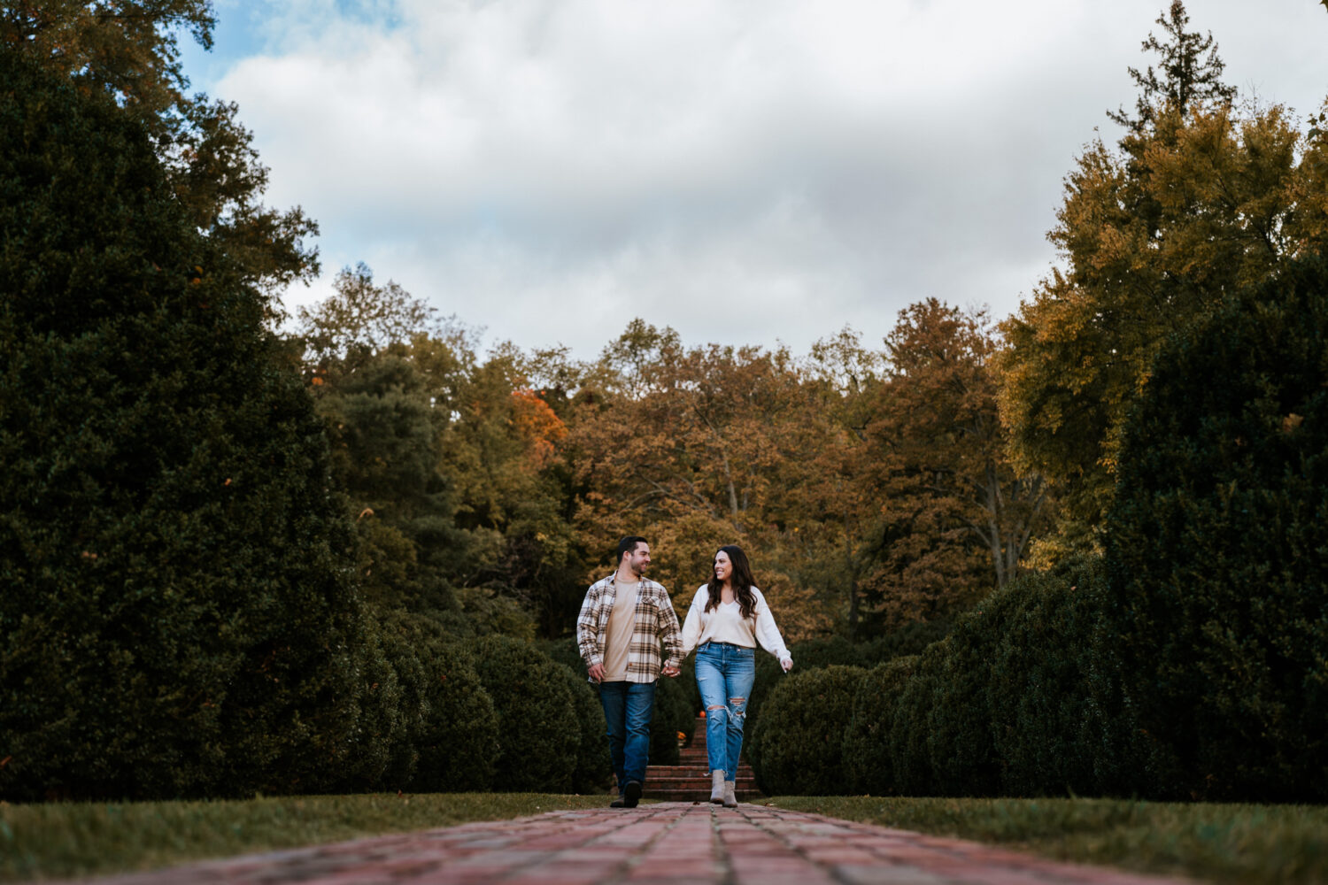 bride and groom walking together in Morven Park for their engagement session