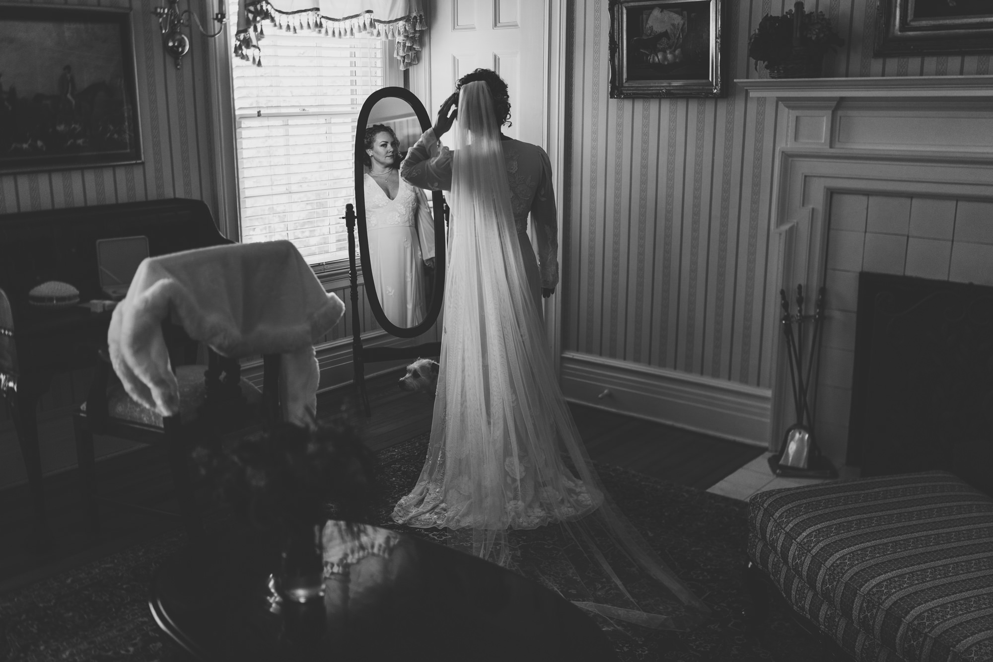 bride looking in the mirror and adjusting her hair