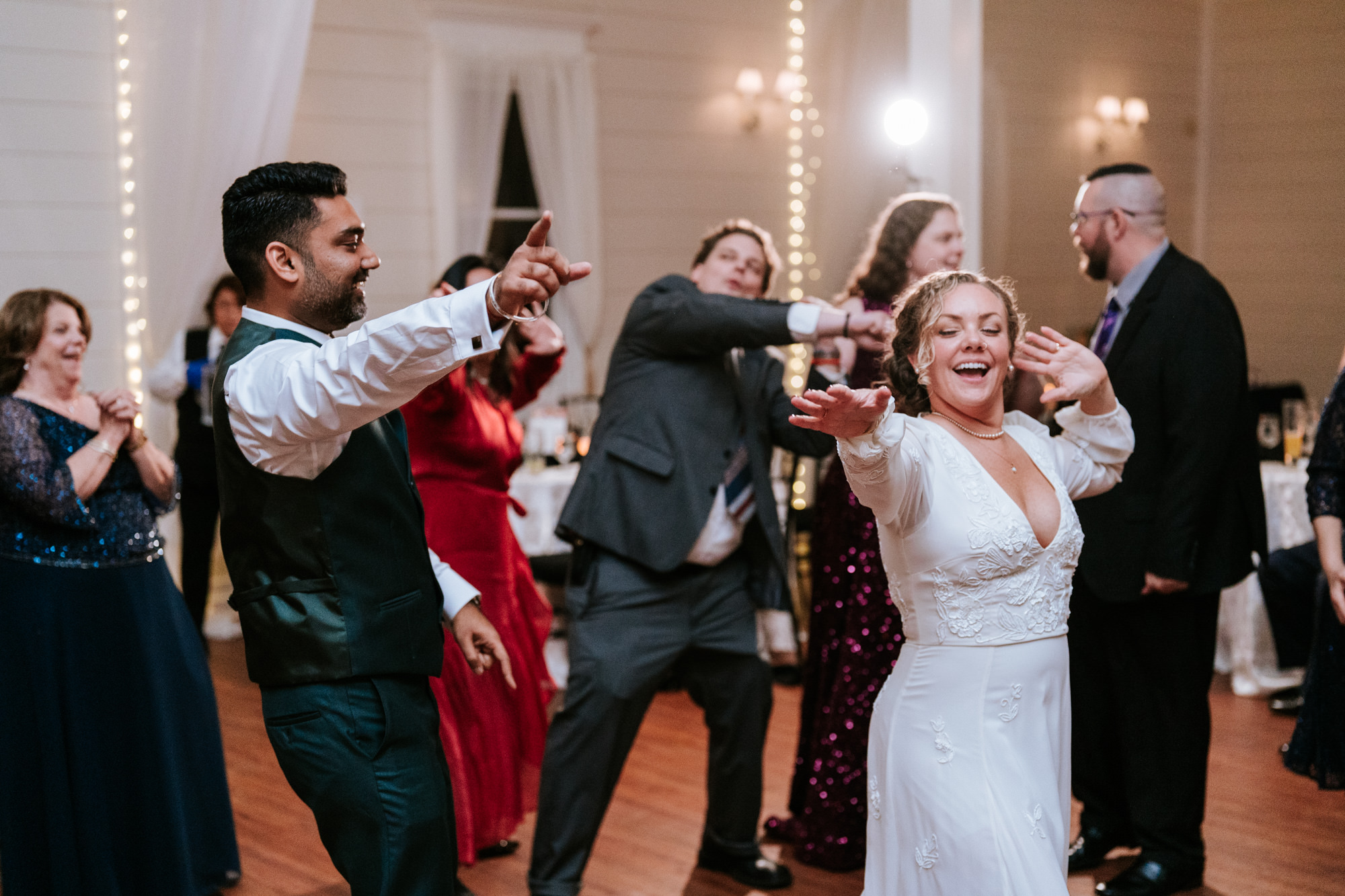 bride and groom having fun on the dance floor together
